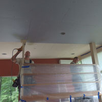 Two brothers (could almost have been twins) more than half way to getting the sheet rock up