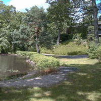 The beach, visible at the far left of the pic above. Good for kids and launching boats, but goes out too shallowly for adults to go swimming. There's a rocky point to the left of this pic where we go in the water.