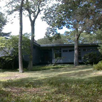 The left side of the house, viewed from deep in the back yard. The BRs etc. are in the wing on the right. The "front door" is in the center of the pic, i.e. in the back of the house, just like our former house in Wellesley.