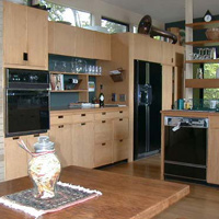 The rear of the kitchen. Note tuba up above. Table came from the kitchen in Wellesley. There's a fireplace in the wall just to the left of this pic that gets used for cooking (and warmth) during winter.